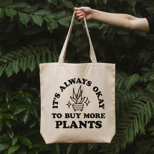 a person holding a bag that says it's always okay to buy more plants