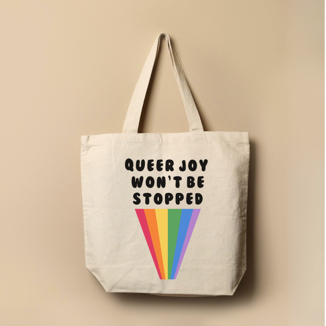 a tote bag hanging on a wall with the words queen joy won't