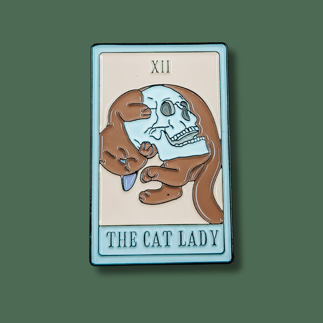 a card with a cat holding a human skull