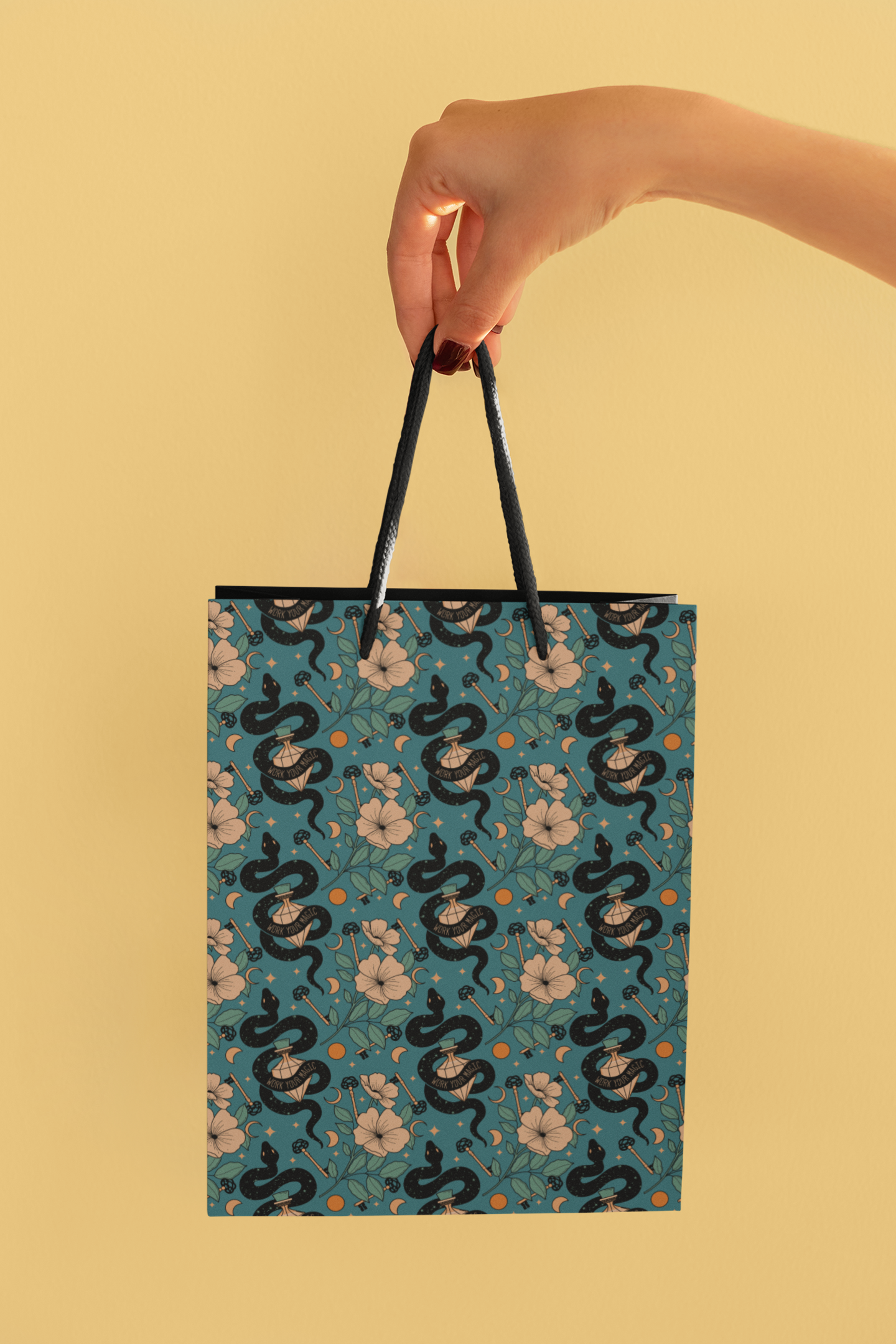 a hand holding a shopping bag with a pattern on it