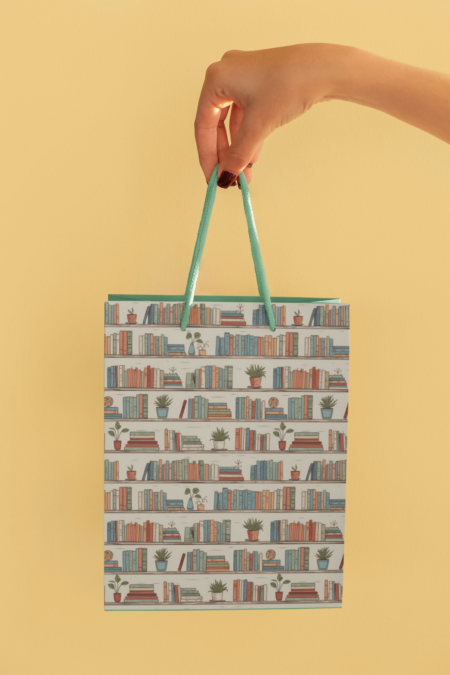 a hand holding a shopping bag with books on it