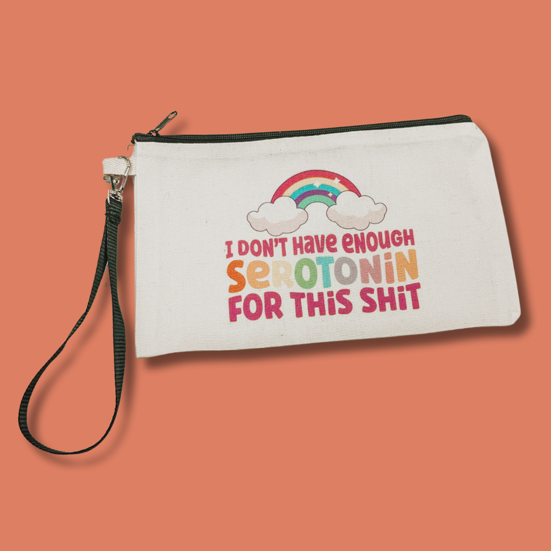 a white zippered pouch with a rainbow on it